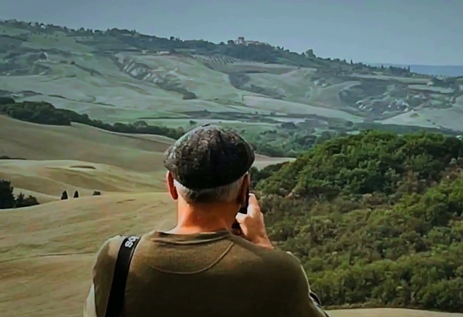 Guest photographing the rolling Crete Senesi hills near Pienza