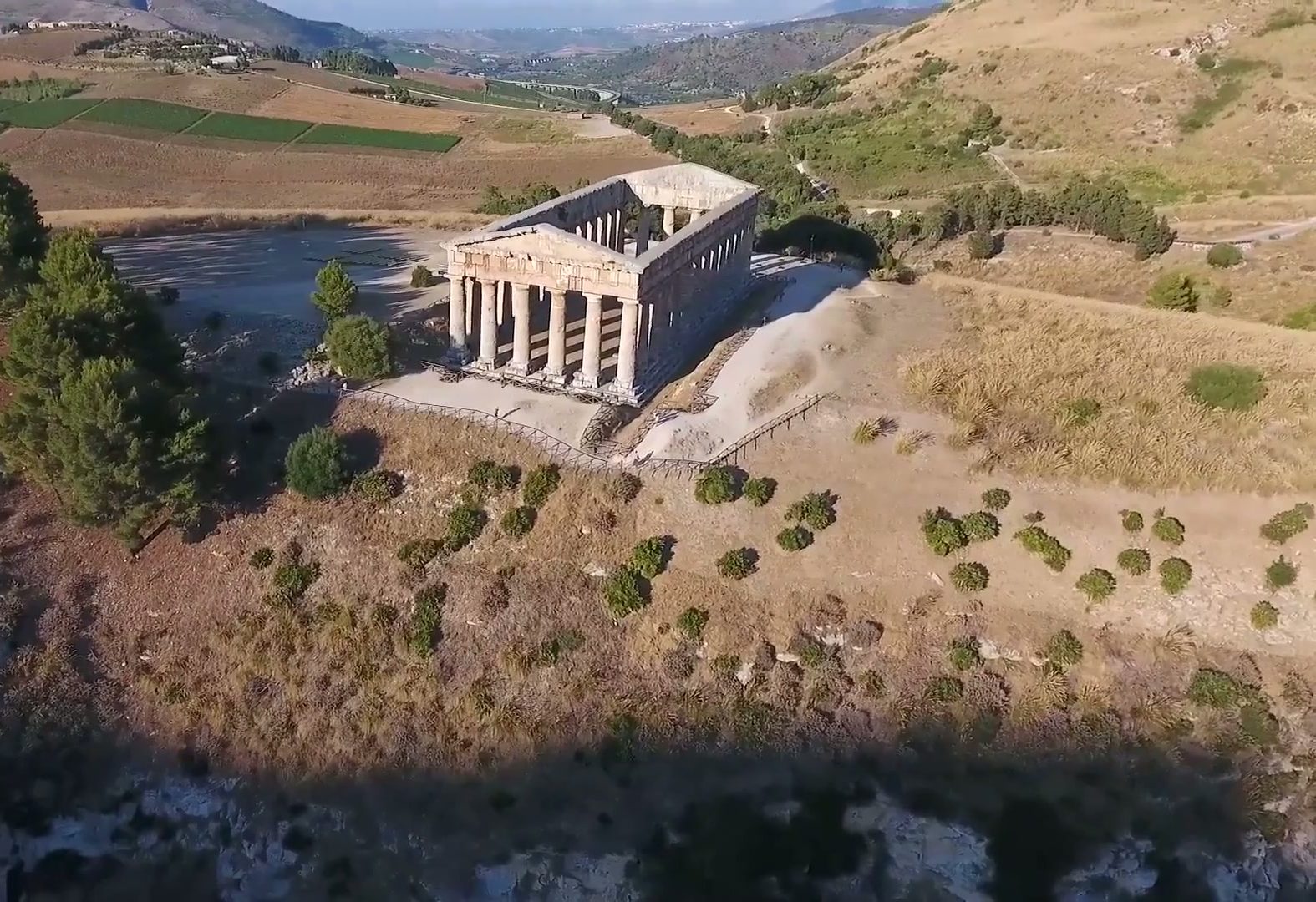 Aerial view of Segesta's ancient temple surrounded by golden Sicilian hills