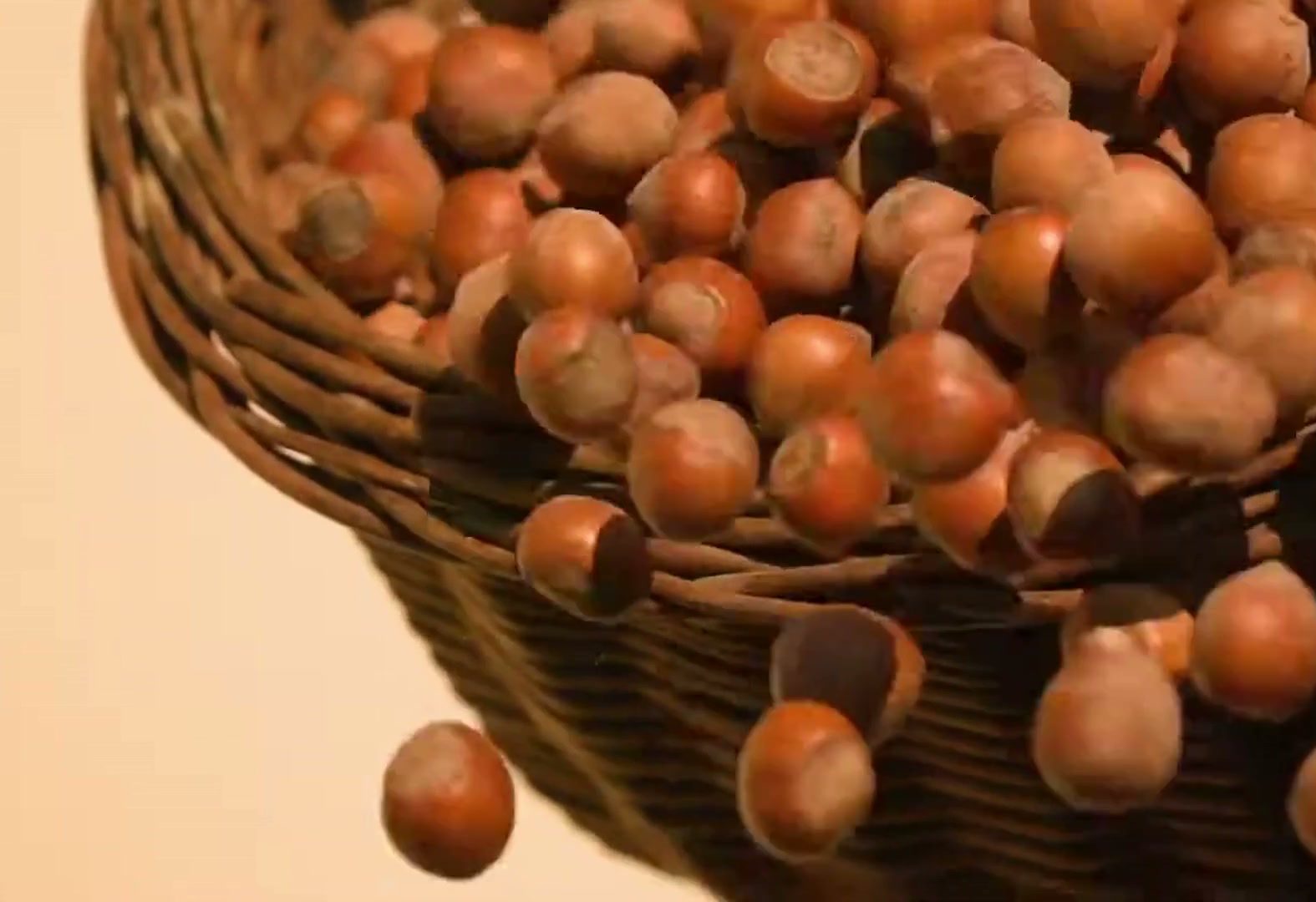 Golden-brown hazelnuts spilling from a wicker basket